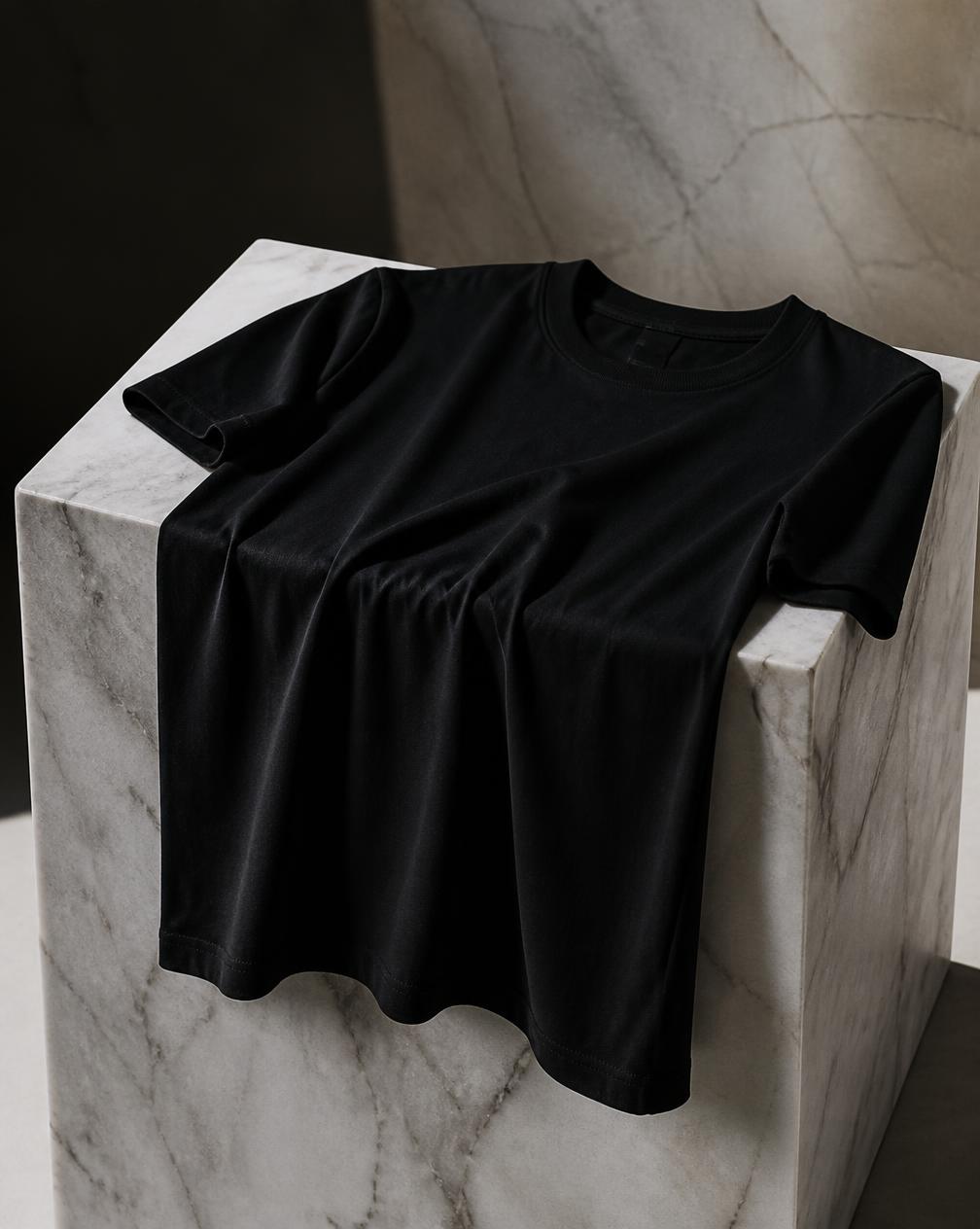Forum Tee in obsidian draped over a marble pedestal