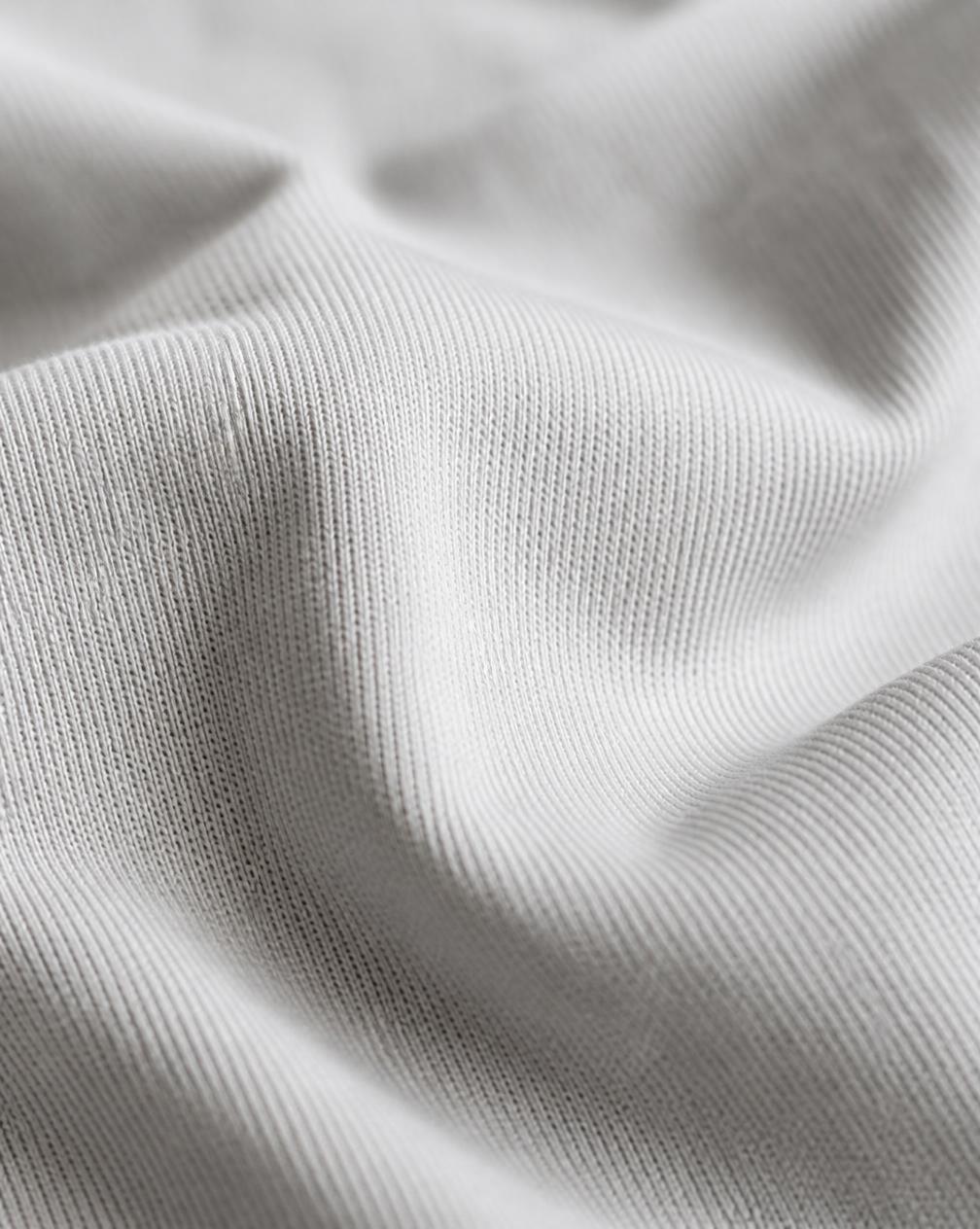 Close-up texture of the Statue Tee fabric